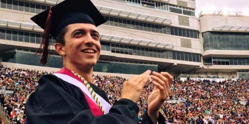 Trey Good clapping at commencement in Lane Stadium