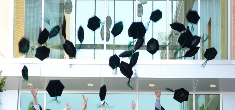 Graduation caps in the air