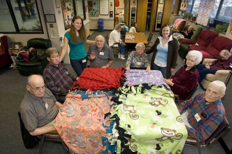 A Caring Hands member works to make a blanket.