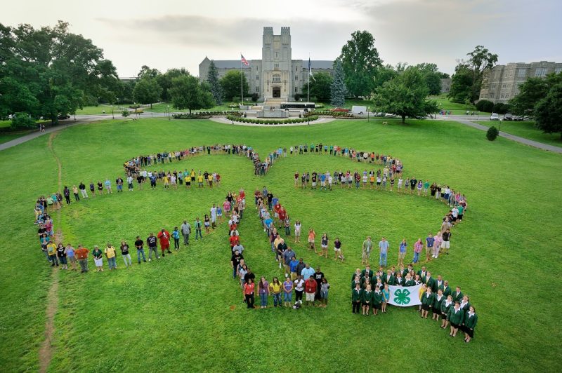 4-H members stand in the organization's signature formation on Virginia Tech's verdant Drillfield.