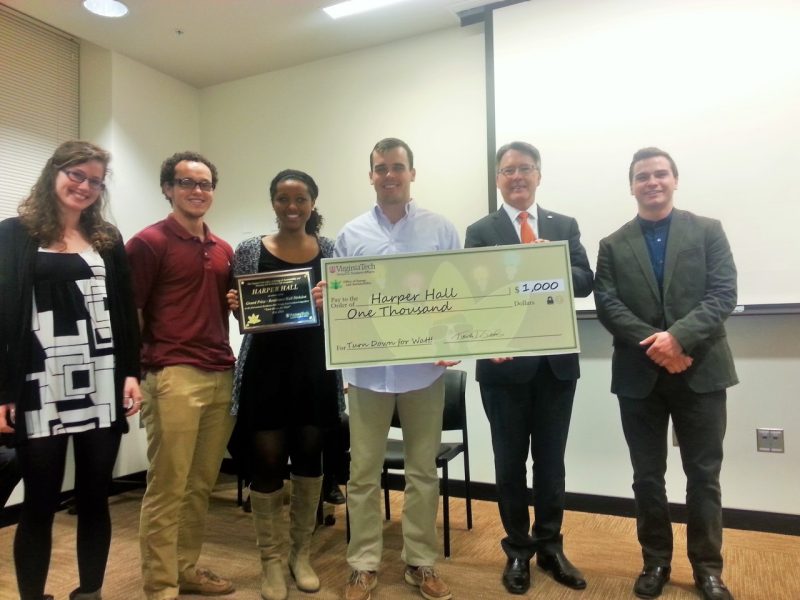 Residents of Harper Hall are awarded a $1,000 check for winning the competition.