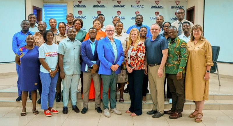 Faculty wearing business casual in a variety of colors posing for a photo