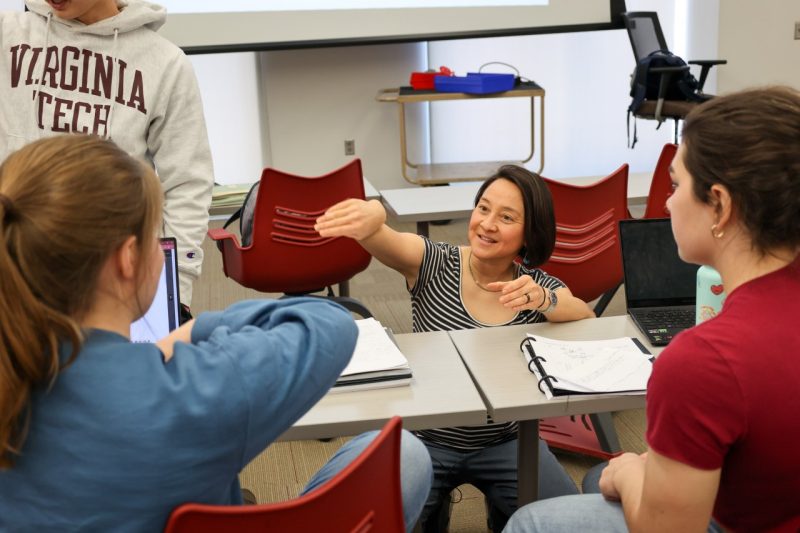 Alma Robinson working with physics students.