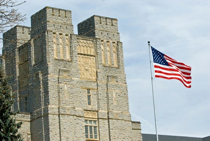 Burruss Hall and an American flag pole 