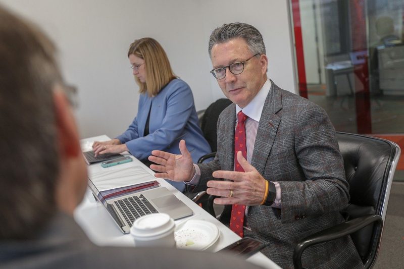 President Sands speaks to others at a table with Dean Julie Ross to his right.